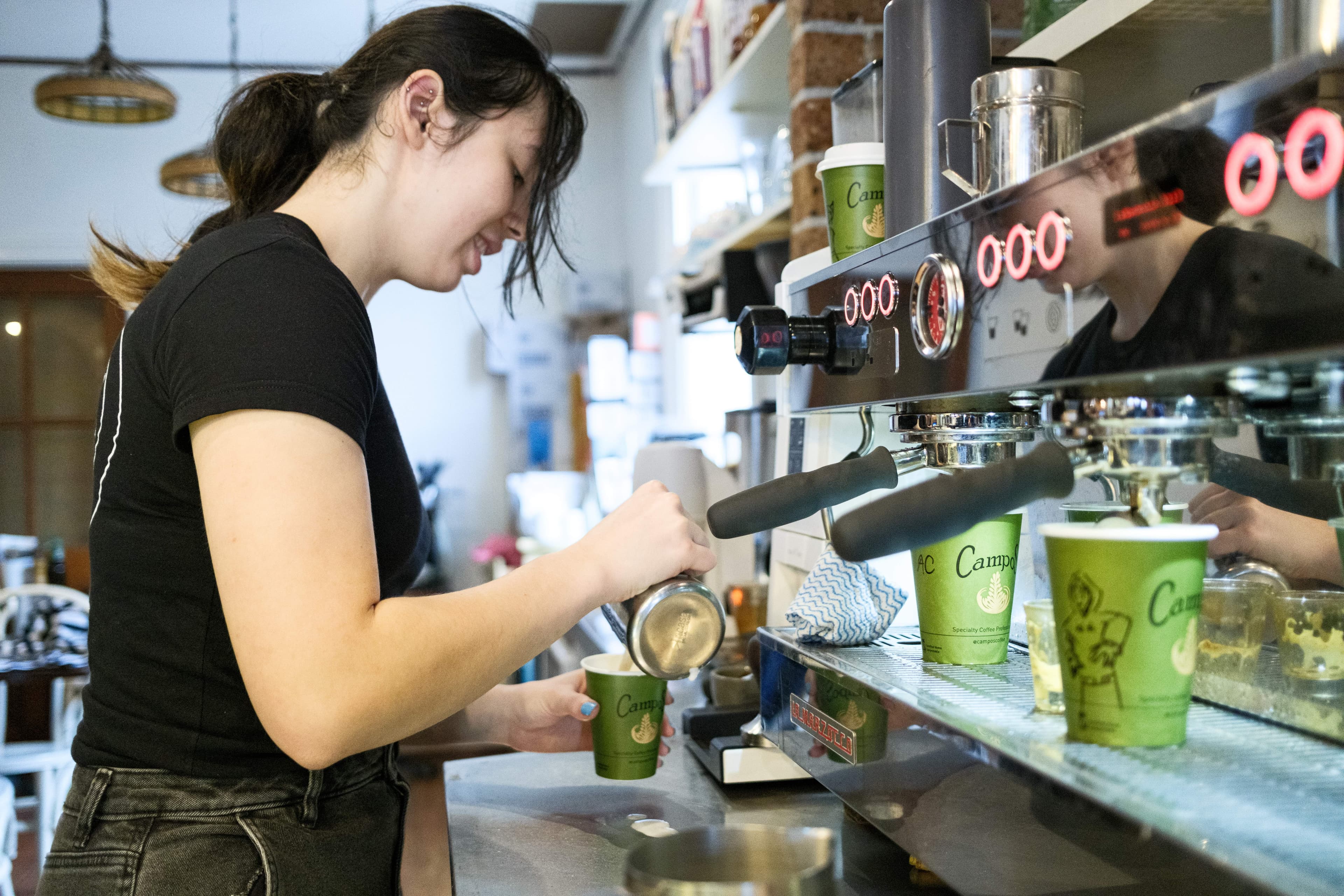A barista pulls a shot from the Campos espresso machine inside Montgomery Street Cafe.